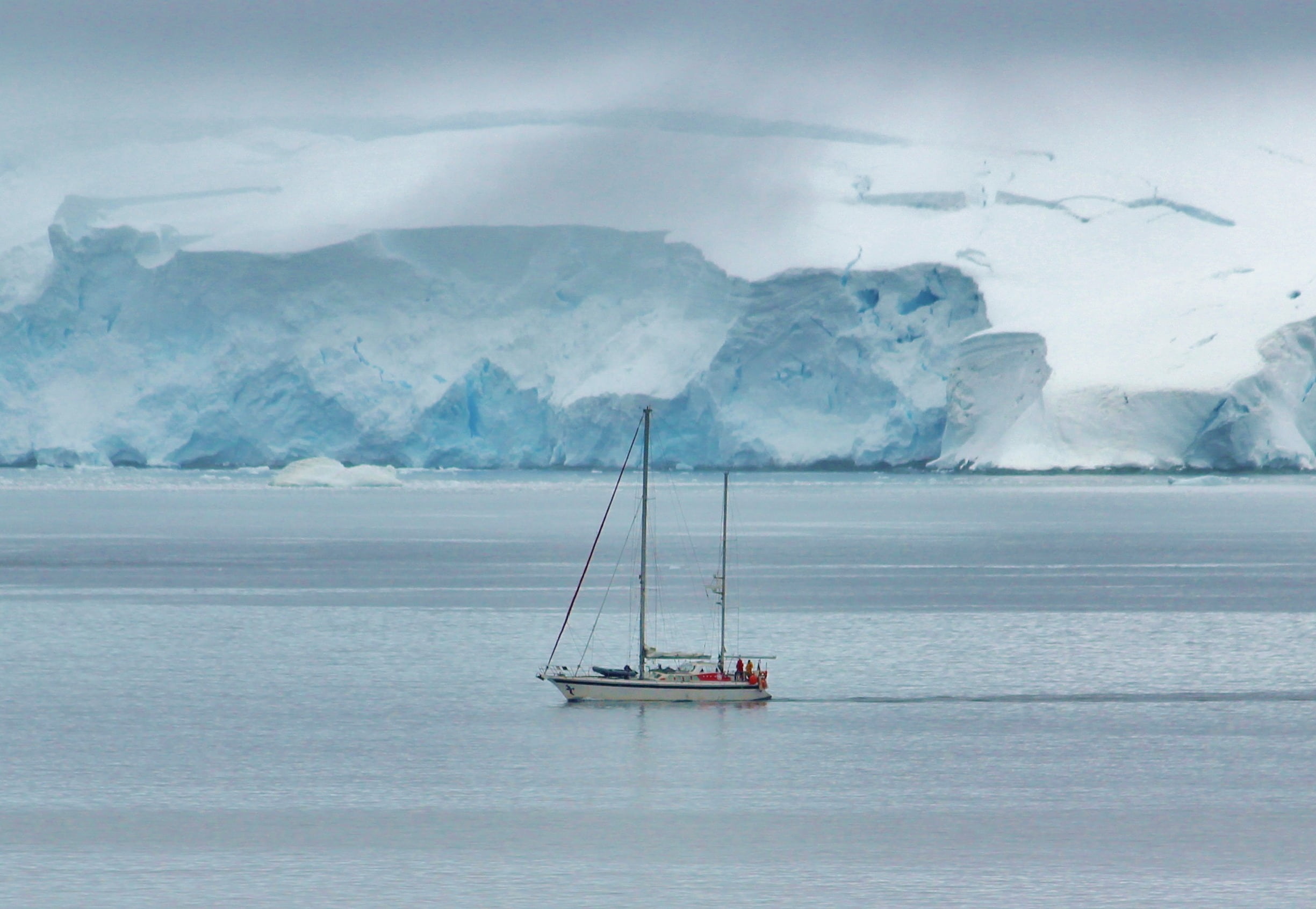 Boat going past iceberg photo